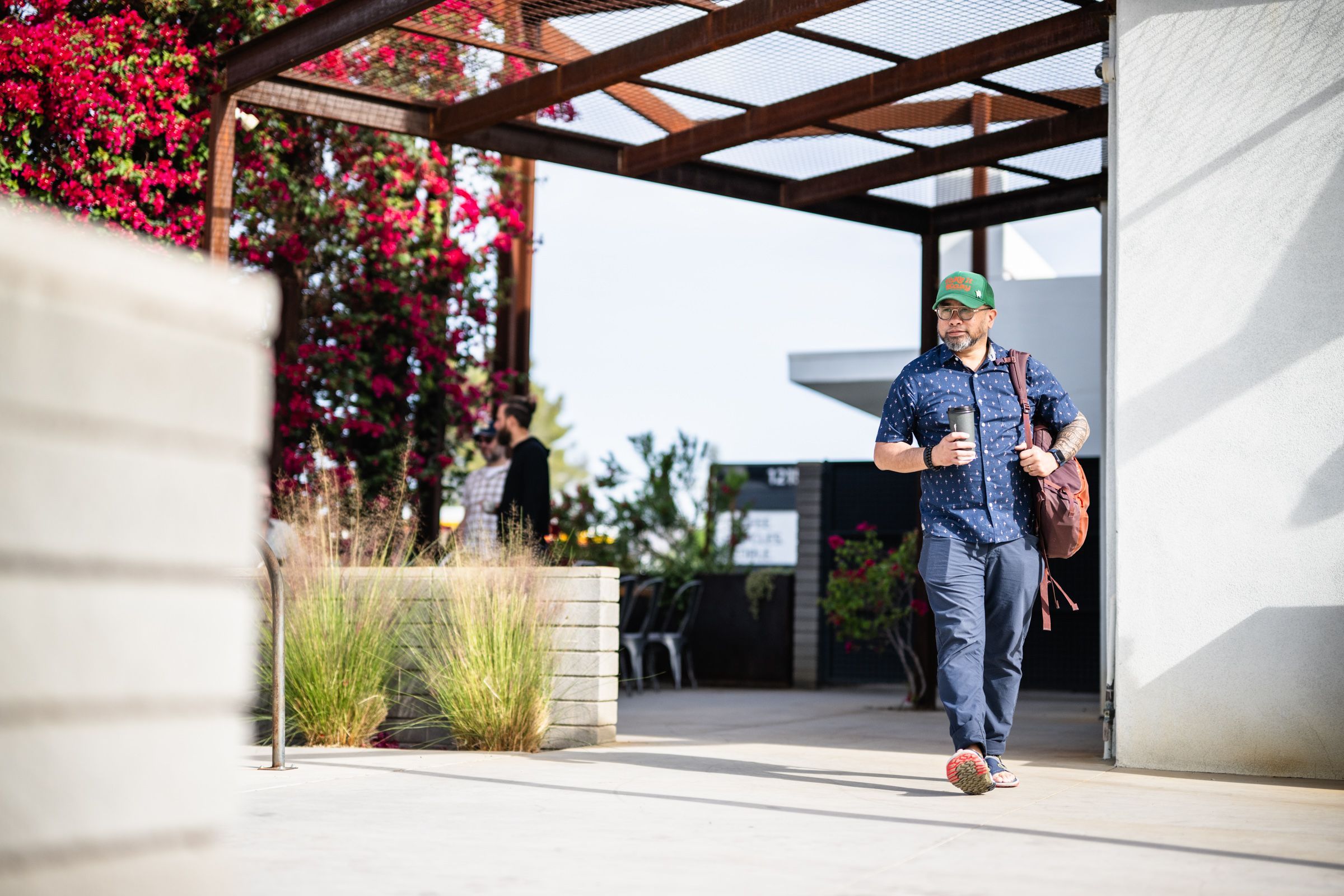 Verge Apache Junction man walking out of a coffee shop with a coffee in hand